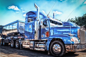 blue tractor trailer on road 