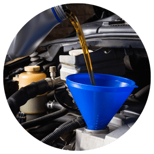 engine oil being poured into a funnel in an engine